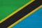 A rustic old Tanzania flag on weathered wood