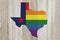 A rustic old Texas pride flag with state map on weathered wood