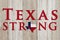A rustic old Texas Strong message