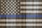 A rustic old thin blue line flag on weathered wood