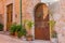 Rustic old wood entrance door with stone arch of mediterranean house