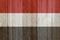 A rustic old Yemen flag on weathered wood