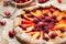 Rustic open pie with peach and raspberry