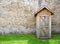 Rustic outhouse and vintage stone wall