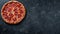 Rustic pizza on black background with tomato, cheese, and italian flavors, space for text