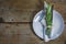 Rustic place setting, plate with silverware, napkin and rosemary