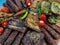 Rustic platter prepared for tourists with mici, pork neck on wooden platter