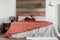 Rustic poster with two ducks, wooden bookshelf and double bed with pillows and duvet