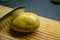 Rustic potato on a wooden chopping board with silver stainless steal knife for cutting