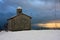 Rustic provincial stone church in the cold of the white snow in the mountains