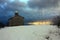 Rustic provincial stone church in the cold of the white snow in the mountains