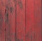 Rustic red wooden table surface with black stain