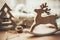 Rustic reindeer christmas toy on wooden table on background of l