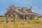 A rustic, rundown, old abandoned, ruined, farm house in the countryside of a prairie in Colorado