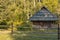 Rustic rural wooden cabin village house Ukraine country side scenic nature environment sun light on foliage