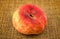 Rustic shot of flat saucer doughnut peach fruit