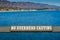 Rustic sign saying `No Overhead casting` on a pier in California