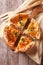 Rustic sliced chicken pie close-up on the table. Vertical top vi