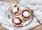 Rustic small galeta pies with fresh berries and vanilla ice-cream on silver dish over a piece of white linen fabric
