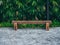 Rustic solid railway sleeper wooden bench on concrete floor