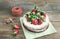 Rustic spicy ginger cake with cream-cheese filling and fresh strawberries with a rough wood background