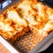 Rustic spicy lasagne with basil on the tin