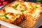 A rustic spicy lasagne with basil on the tin