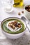 Rustic spinach and broccoli rich soup puree with cream and croutons