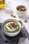 Rustic spinach and broccoli rich soup puree with cream and croutons