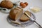 Rustic still life of sliced rye bread on a shabby board, knife, butter, eggs on a light wooden table