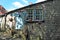 Rustic stone cottage on a steep sloping cobbled street between hebden bridge and heptonstall in yorkshire with colorful flower bas