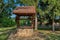 Rustic stone well with bucket and drinking water