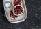 Rustic strawberry tart on a dark stone background.