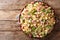 Rustic style Ditalini pasta with green peas, ham and cheese closeup on a plate. horizontal top view