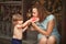 Rustic style lifestyle child boy feeding mom fresh watermelon in country yard