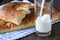 Rustic style. Milk is poured into a glass, bread on a kitchen to