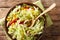 Rustic style savoy cabbage salad with corn, onions and bell pepper close-up in a bowl. Horizontal top view