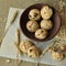 A rustic styled photo with grain homemade biscuits on a wooden plate, peanuts and ears