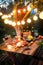 Rustic table with appetizers and wine in illuminated garden