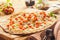 Rustic Thin Crust Pizza on Wooden Cutting Board