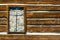 Rustic timber wall with a window barricaded by rocks