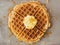 Rustic traditional waffle with butter and maple syrup