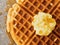 Rustic traditional waffle with butter and maple syrup