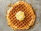 Rustic traditional waffle with butter and maple syrup