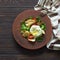 Rustic vegetable and chicken salad with poached egg