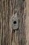 Rustic vintage barn wood door with close up on keyhole