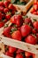 Rustic warehouse setting juicy strawberries in wooden crates with soft natural light for food ads