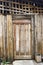 Rustic weathered wooden entry door in rural Laos