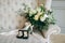 Rustic wedding bouquet and rings in the black box on a luxury sofa. Indoors. Artwork