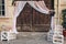 rustic wedding photo zone. wooden barn doors with fabric and white boxes with flowers and candles at stylish wedding photo booth.